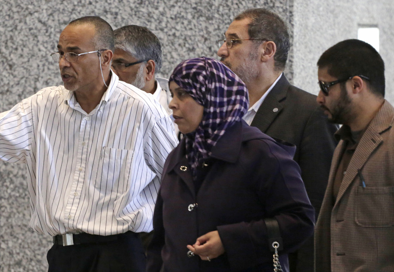 Family and supporters of 18-year-old Abdella Ahmad Tounisi, including his father, Ahmad Tounisi, left, leave federal court Thursday in Chicago.