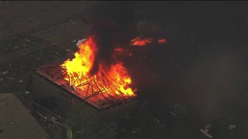 This photo provided by KFOR-TV shows a house fire outside Moore, Okla., Monday, May 20, 2013. A monstrous tornado as much as a mile wide roared through the Oklahoma City suburbs Monday, flattening entire neighborhoods, setting buildings on fire and landing a direct blow on an elementary school. (AP Photo/KFOR-TV)