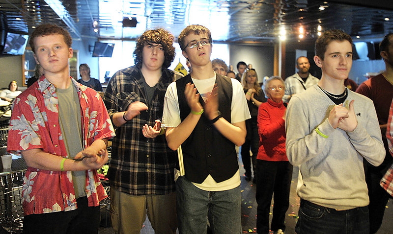 Members of the band Rupture the Fish listen to the announcements of the winners. At left is Scott Ralston, who won "best guitarist."