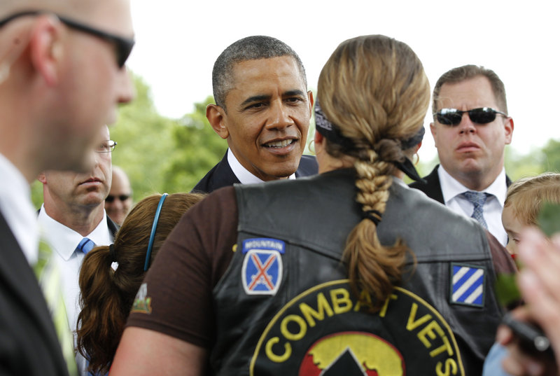 President Obama greets Iraq and Afghanistan war veteran Eilene Henderson in Section 60 of Arlington National Cemetery in Arlington, Va., during his Memorial Day visit there Monday.