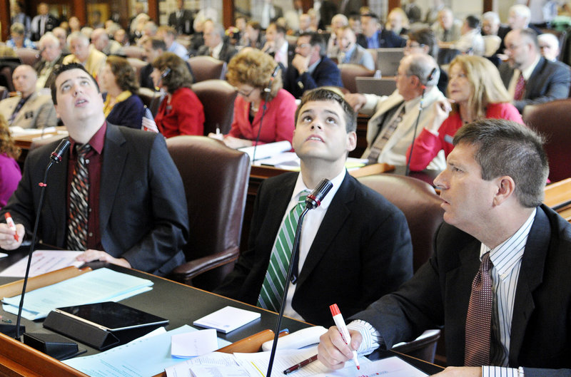 Representatives Kenneth Fredette, right, R-Newport, Alexander Willette, R-Mapleton, and Tyler Clark, R-Easton, watch the vote in the House of Representatives on Wednesday, June 26 to override Gov. Paul LePage's veto of the state budget. Fredette and Clark voted to overturn the veto, while Willette voted to uphold the veto.