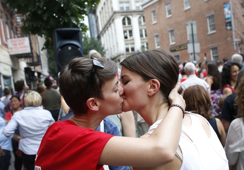 Members of the LGBT community and their supporters gather to celebrate two decisions by the U.S. Supreme Court, one to invalidate parts of the Defense of Marriage Act and another to uphold a lower court ruling that struck down California's controversial Proposition 8, during a rally in New York's Greenwich Village, Wednesday, June 26, 2013. (AP Photo/Jason DeCrow)