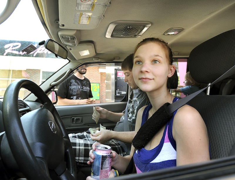 Tanika Newell from Westbrook gets gas at Ralph's/Holly's in Westbrook as she and other motorists react to higher gas prices on Monday, July 15, 2013.