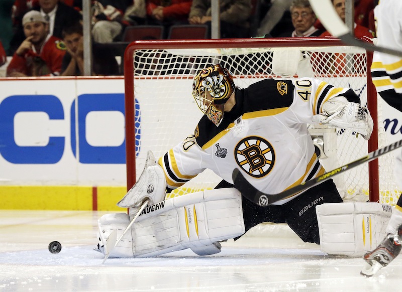 Boston Bruins goalie Tuukka Rask (40) blocks a shot by Chicago Blackhawks center Andrew Shaw (65) during the first overtime period of Game 1 in their NHL Stanley Cup Final hockey series, Wednesday, June 12, 2013, in Chicago. (AP Photo/Nam Y. Huh)