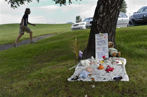 In this July 2013 file photo, a makeshift memorial for victims of an oil train derailment and explosions is set up in Lac-Megantic, Quebec. 47 people died in the disaster, and a plaintiff's motion says their families are entitled to millions of dollars in compensation. (AP Photo/The Canadian Press, Paul Chiasson)