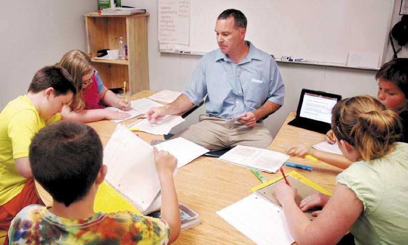 Fifth-grade teacher Michael Louder works in a small group with students at Canaan Elementary School during a reading workshop Friday. The school was one of two in Skowhegan-based School Administrative District 54 that Department of Education Commissioner Stephen Bowen visited that day.