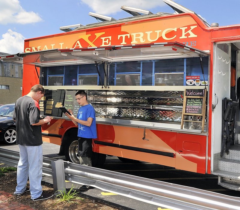 Because the Small Axe Truck is over the city’s 20-foot size limit, it must serve its meals from a private parking lot on Congress Street.