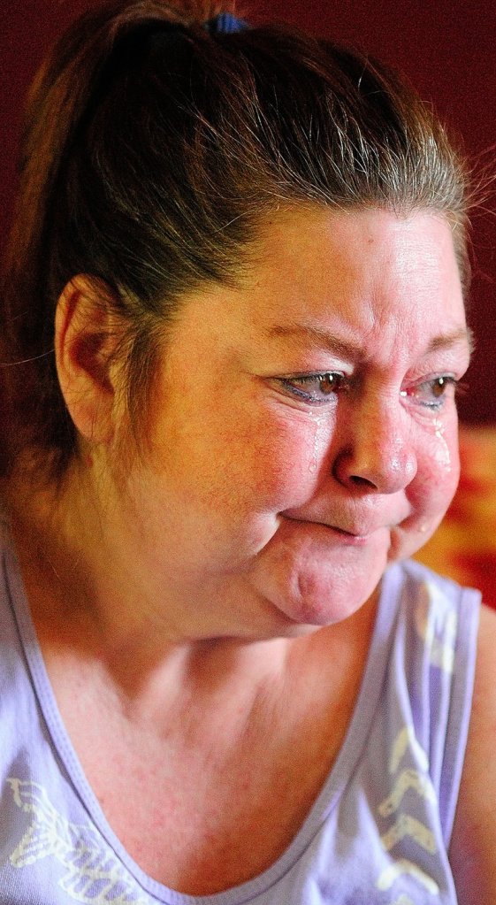 Pamela Tardiff cries while telling of her frustrations with the new ride scheduling system Friday in Augusta. Tardiff uses an electric-powered wheelchair and has had trouble getting rides to doctor’s appointments.