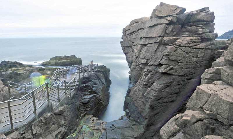 Acadia National Park would be among the parks closed under a government shutdown. Here, tourists wait for the right wave to roll in at Thunder Hole at the park on Mount Desert Island. Kennebec Journal File Photo / Michael G. Seamans