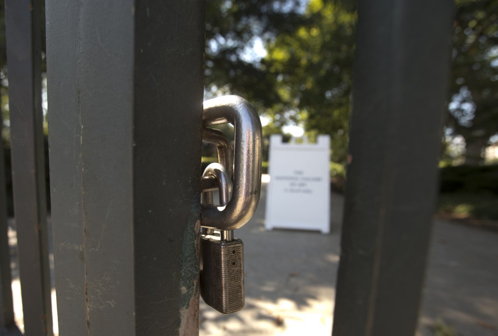 A pad lock secures the iron gate of the closed National Gallery of Art Sculpture Garden in Washington, Wednesday, Oct. 2, 2013. President Barack Obama summoned congressional leaders to the White House on the second day of a partial government shutdown that has furloughed hundreds of thousands of workers and closed military cemeteries as far away as France. Republican leaders welcomed the Wednesday afternoon meeting but questioned whether Democrats were ready to deal.