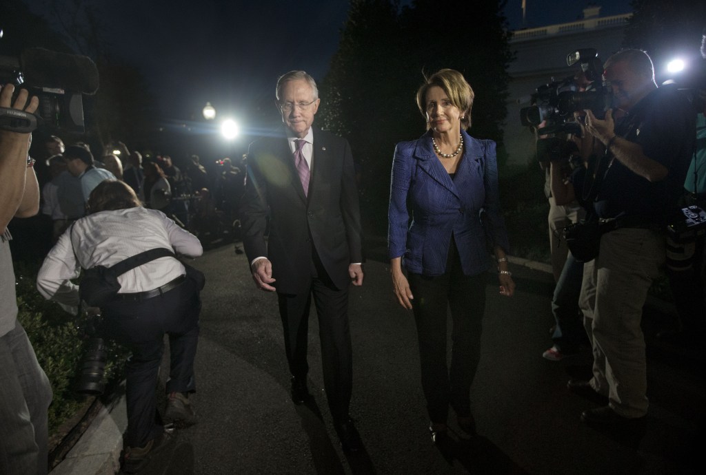 House Minority Leader Rep. Nancy Pelosi, D-Calif., right, walks with Senate Majority Leader Sen. Harry Reid, D-Nev., left, after speaking to reporters following a meeting with President Barack Obama and the Republican leadership at the White House in Washington, Wednesday, Oct. 2, 2013. Obama and congressional leaders met at the White House on the second day of a partial government shutdown.