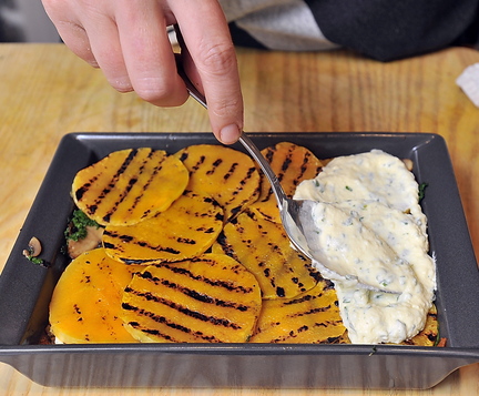 Rudalevige spoons a ricotta cheese and herb mixture, left, over grilled butternut squash for her lasagna.