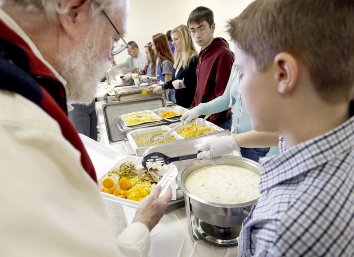 Volunteers prepare Thanksgiving meals at Most Holy Trinity Church in Saco for delivery to homes in Saco, Biddeford and Old Orchard Beach on Thursday. They also served dinners to 350 at the church.