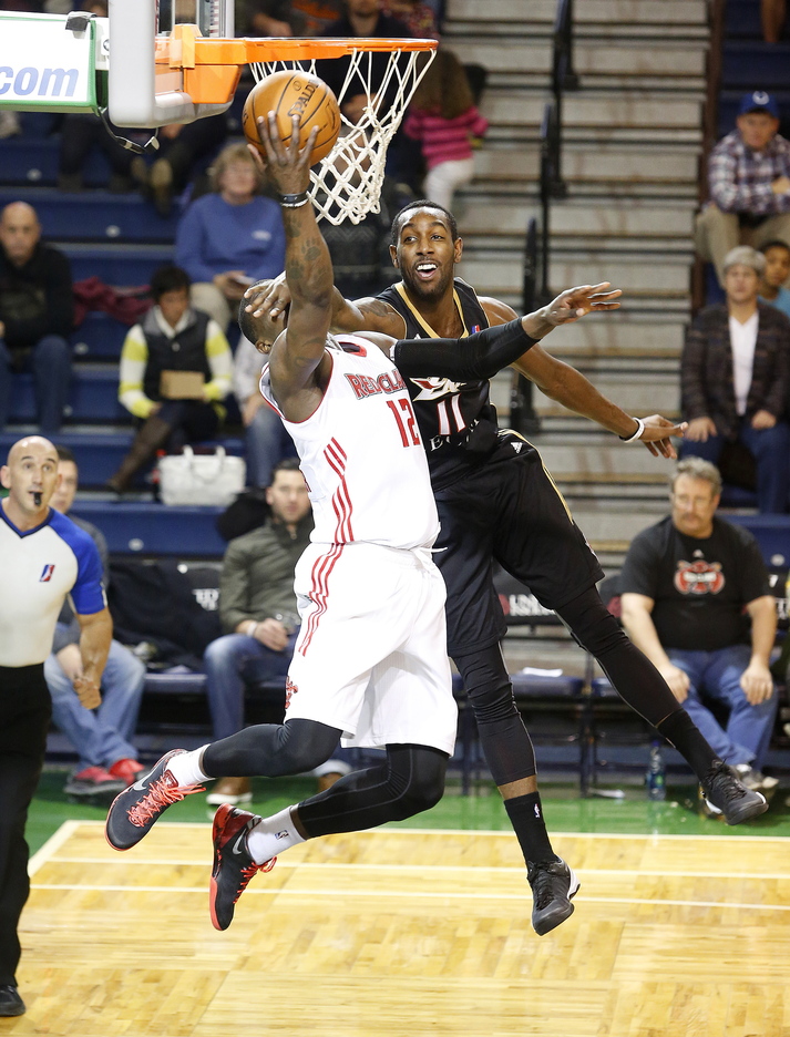 Despite the visual impairment from Erie's of C.J. Leslie, Maine's Jermaine Taylor scores during the second quarter of Sunday's game at the Portland Expo. Taylor went down in the second half with what could be a serious injury to his left knee.