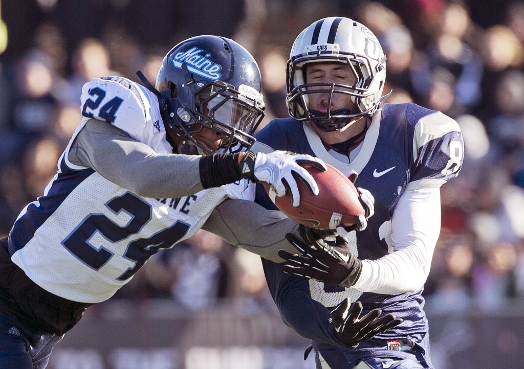 Maine defensive back Khari Al-Mateen breaks up a pass intended for New Hampshire wide receiver Jared Allison last season. 