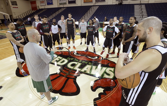 Coach Mike Taylor of the Maine Red Claws has 17 players at center court at the Portland Expo for practice. Soon those 17 players will become 10 as the Red Claws undergotryouts while preparing for the Nov. 22 opener against the Springfield Armor at the Expo.