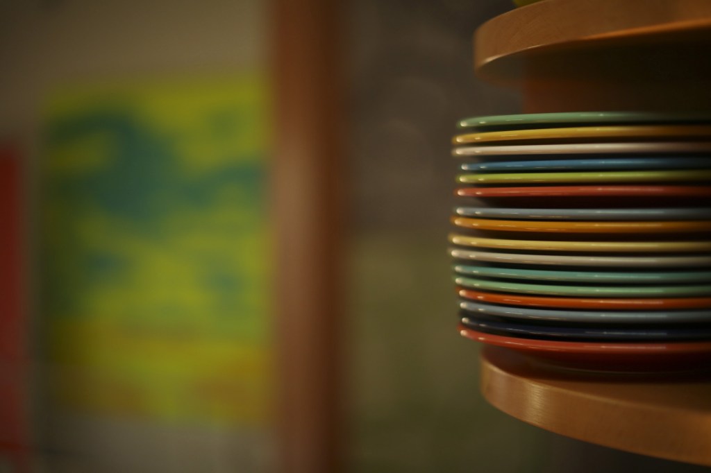 Curved corner cabinets display some of the couple’s colorful Fiestaware and vintage collectibles.