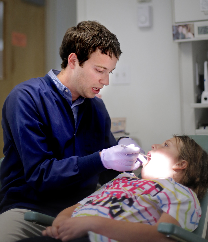 Dr. Michael Dowling treats patient Nevaeh LaPlanche, 7, of Wiscasset, at Falmouth Pediatric Dentistry on Wednesday. Dowling says new MaineCare audits carry excessive fines for small errors and the state has the ability to make the audits more fair.