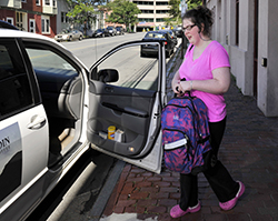 Rebecca Lee gets a ride home last summer from the Goodwill Neurorehab Services in Portland, which happened to be working nearby that day, after her schedule MaineCare ride failed to show up. State officials say they are still evaluating the performance of a Connecticut company that has mishandled medical transportation arrangements for thousands of MaineCare patients since it started working for the state four months ago.