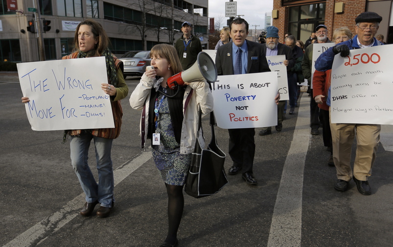 Ashley Gorczyca of Homeless Voices for Justice, holding megaphone, leads a march up Elm Street to the bus stop where a group of protesters rode the No. 5 bus from Portland to the proposed site for DHHS offices in South Portland to highlight the length of the trip.