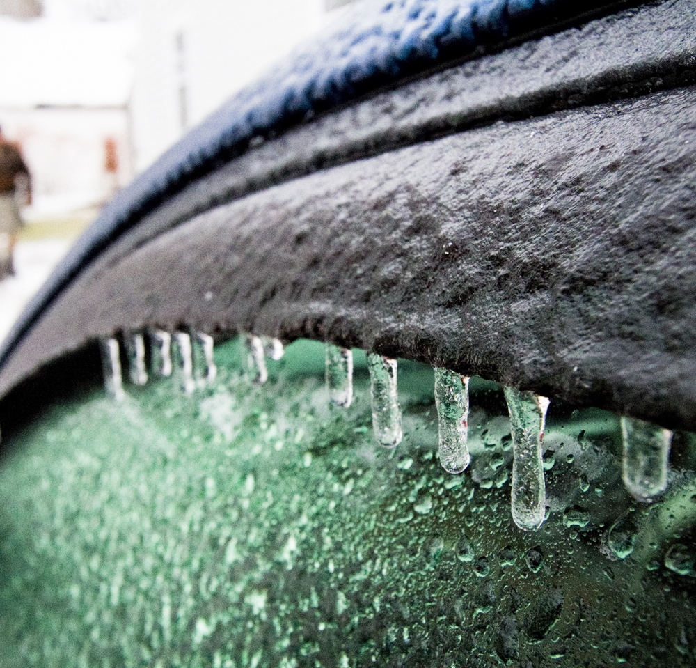 Ice builds up from Sunday’s rain on Mark Storck’s car in his Bridgton driveway. More icing is expected Monday morning with freezing rain forecast to linger until the afternoon.