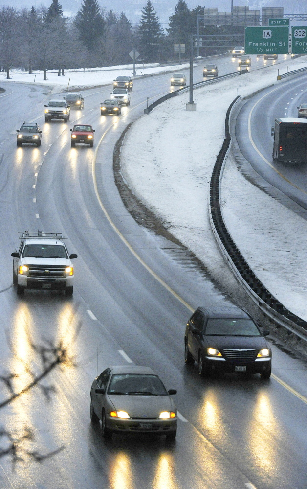 Icy roads and streets caused by freezing rain made for a slippery commuted to work on Monday morning. December 23, 2013. John Ewing/staff Photographer.