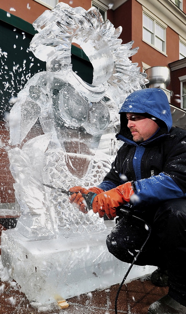 The ice chips fly as Jeff Day of Ice Designs in New Hampshire puts the finishing touches on a sculpture for the 2012 Portland Harbor Hotel Ice Bar.