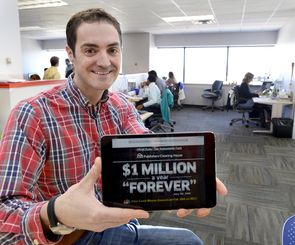 Jason Cianchette, founder of Liquid Wireless, displays an app his company created. He moved his company from Boston to Portland because he wanted to live in Maine.