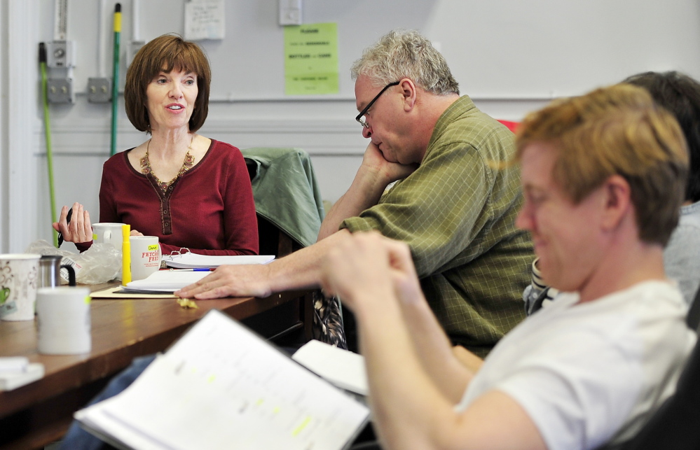 Monica Wood meets with Portland Stage Company actors – including Daniel Noel, center, and Dustin Tucker, foreground – during a reading of her play “Papermaker.” The work is based on an earlier novel, “Ernie’s Ark,” which centers on two families who collide during a strike at a paper mill.