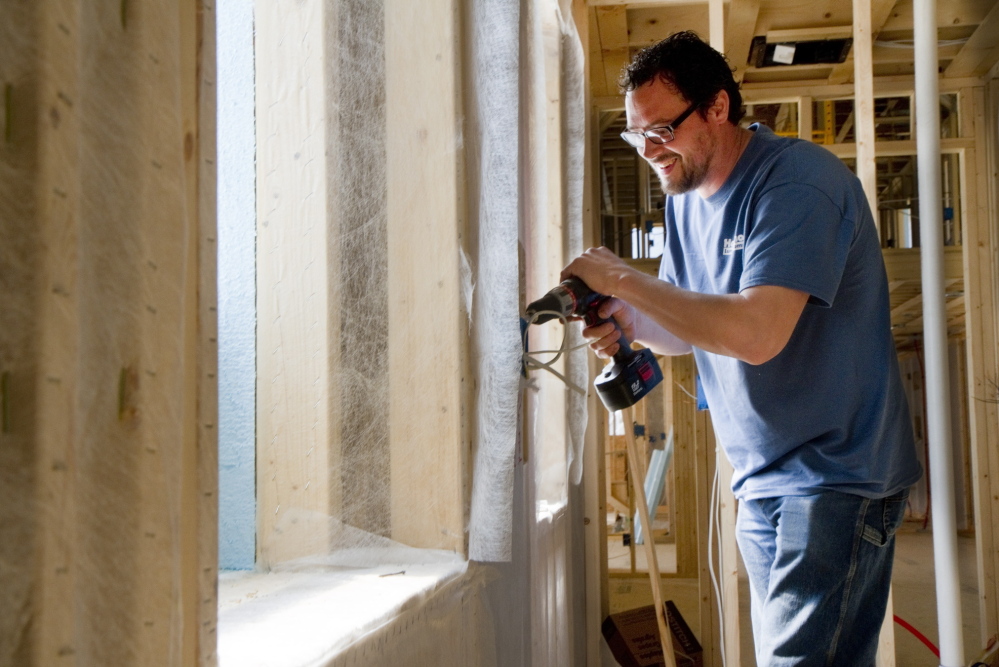 Building contractor Dan Swan works on the net-zero home he is building for Robert Howe in Brunswick. The frame is a double stud offset construction that will allow 10 inches of insulation to be blown in between.