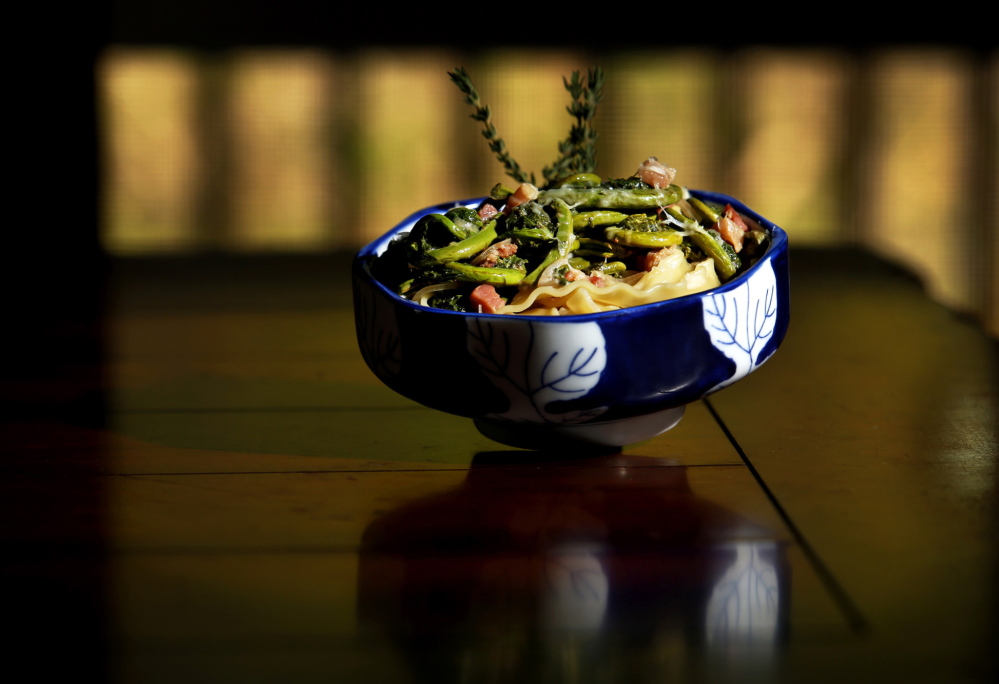 A dish of Mollie Sanders’ Fiddlehead and Panchetta Pasta sits on her kitchen table in Kittery Point.