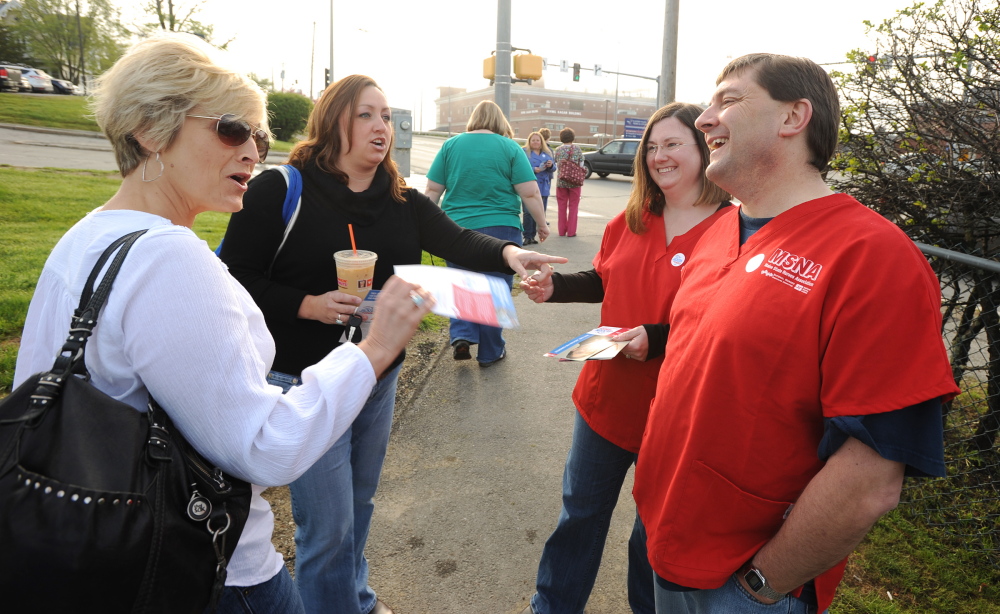 Troy Jackson, right, greets nurses Wendy Cooper-Plaisted, left, and Michelle Pullen, second from left, at Eastern Maine Medical Center in Bangor last month. With Jackson is Jenn Sedgwick, chief steward of the Maine State Nurses Association, which supports his candidacy. Kevin Bennett photo