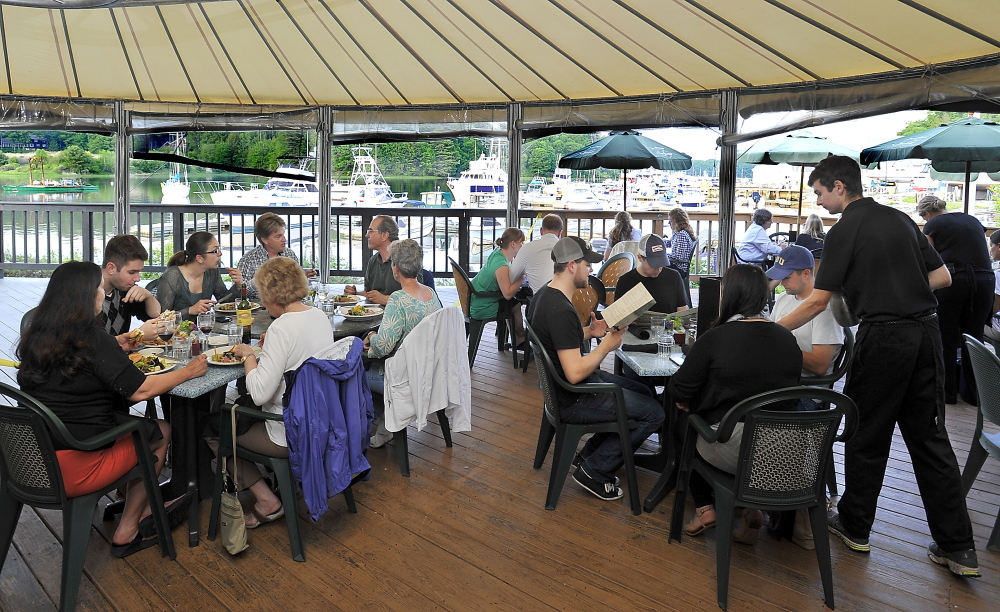 The deck overlooks the Royal River and the adjacent marina at Yarmouth Boat Yard.