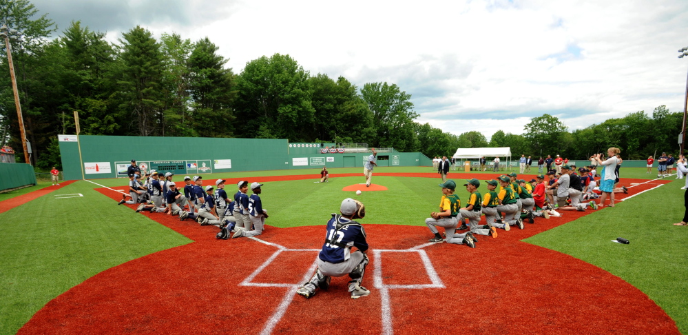 Red Sox legend Jim Rice tosses a strike with a ceremonial first pitch during the dedication of a new  turf field Saturday at Mini Fenway Park in Oakland.