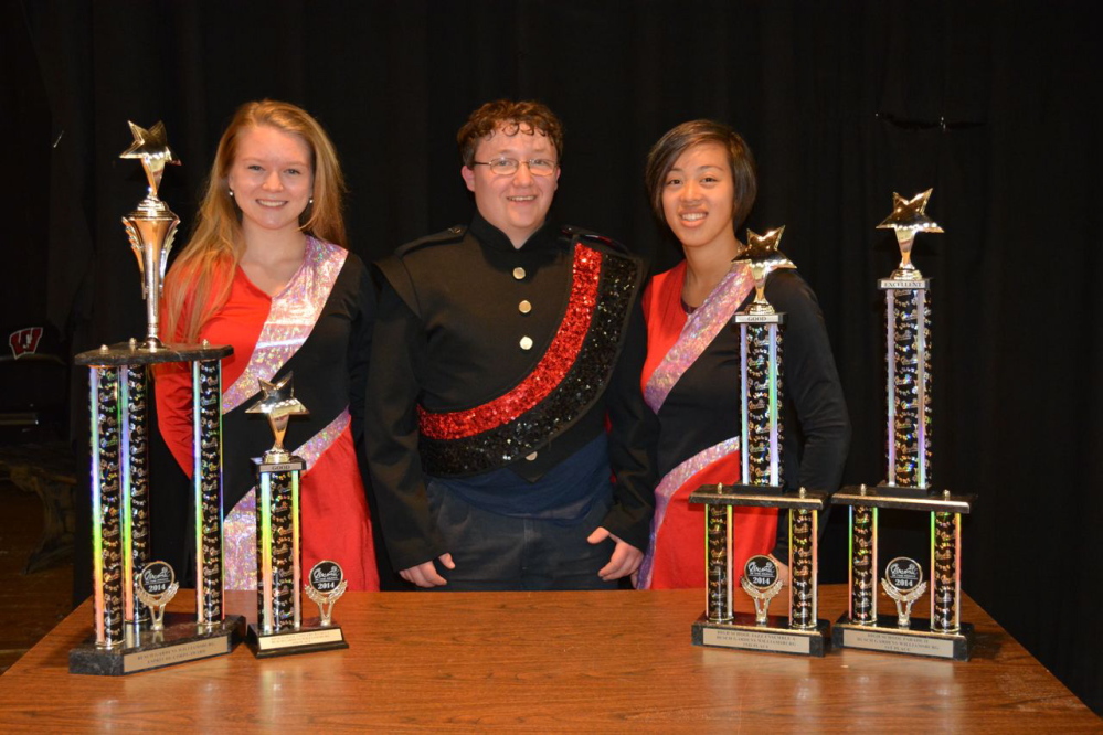 Posing with trophies received at the Music in the Parks band competition at Williamsburg, Va., are, from left, Adrienne Perron (color guard captain), Brandon Cox (drum major) and Emilee Wooldridge (color guard captain). The high school's parade, concert and jazz bands placed first, fourth and second, respectively, and also won the prestigious Esprit de Corps Award for the third time. Photo courtesy Laura Bell