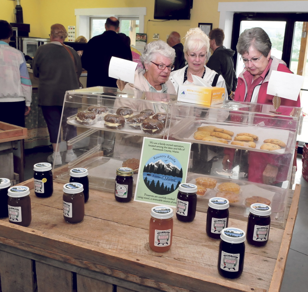 Folks on a bus tour of New England sites stopped at the Sandy River Farm in Farmington on Wednesday. After visiting barns and listening to owner Bussie York visitors including from left Linda Beaumont, Nancy Irving and Bonnie Graham stopped at York’s farm store to look and sample local products.