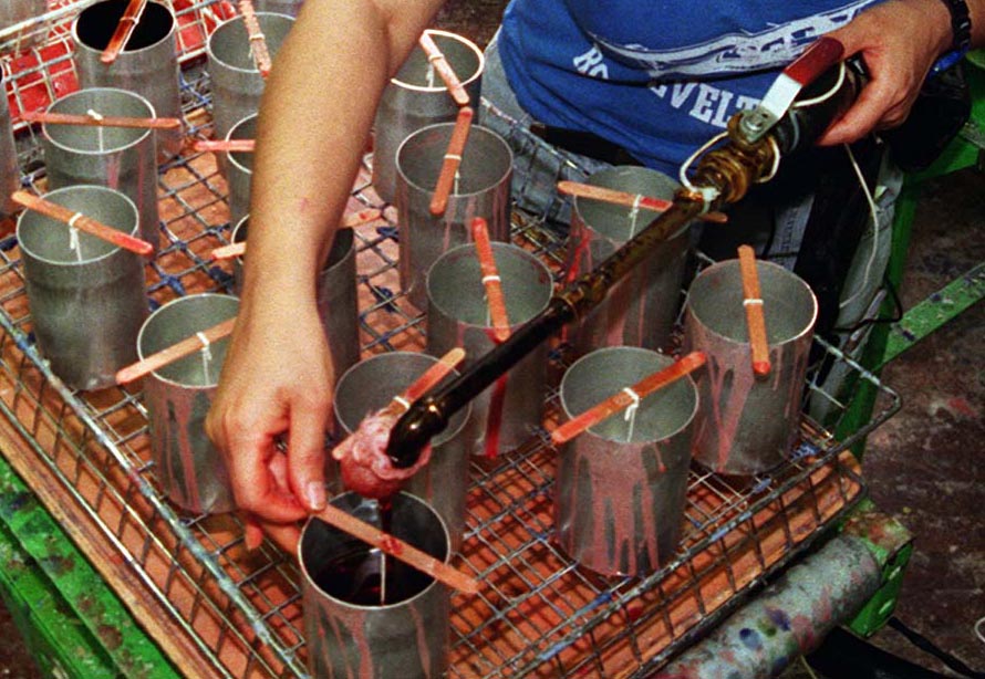 A Village Candle worker fills molds with  hot scented wax at the company's production facility in Brunswick.

Press Herald file