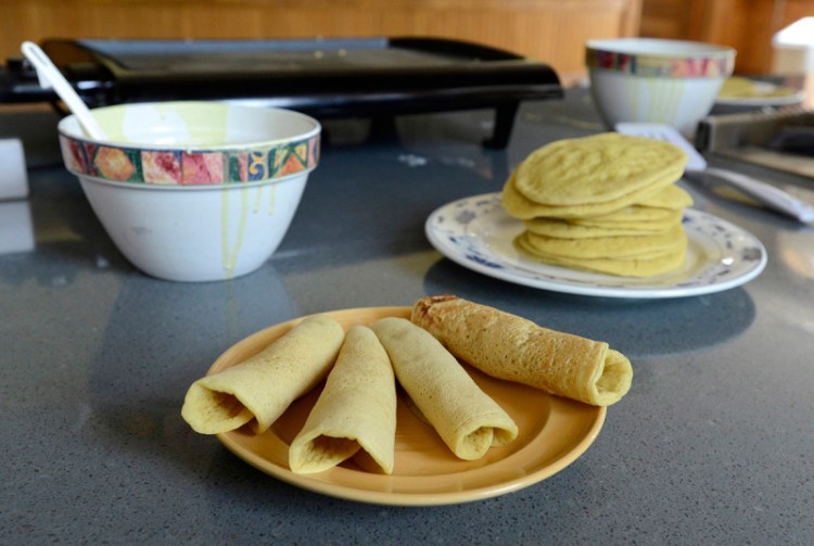 A plate of ployes, ready to be eaten.