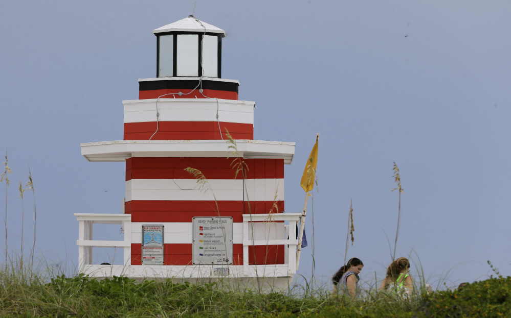 A flag warns of medium hazard, alerting beachgoers to be cautious of moderate surf and currents in Miami on Tuesday.