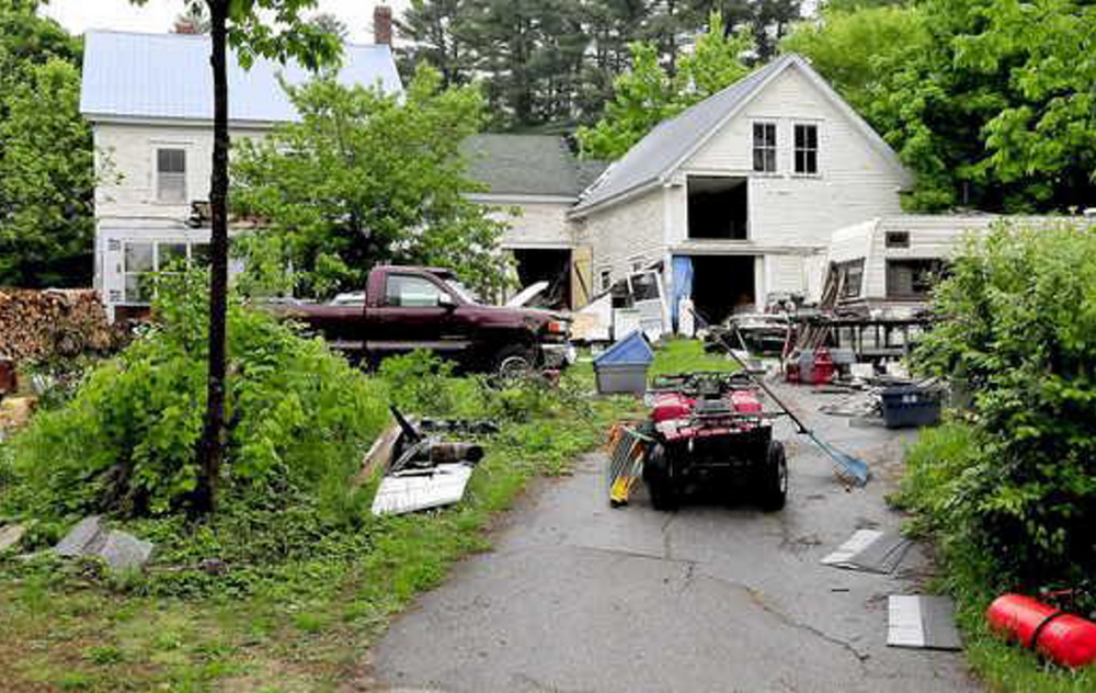 Duane Pollis of Wilton has cleaned up some of the debris that was on his property as of June, above, and town officials are giving him time and encouragement to complete the job.