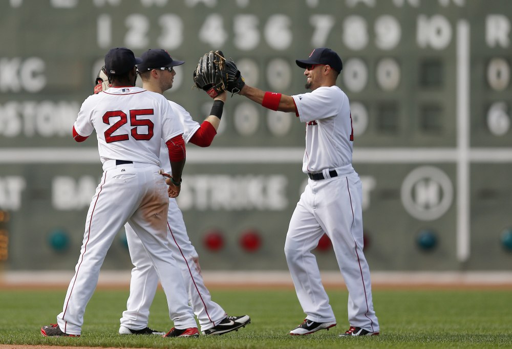 Boston's Jackie Bradley Jr. (25), Daniel Nava, center, and Shane Victorino celebrate after defeating the Kansas City Royals 6-0  in Boston on Sunday.