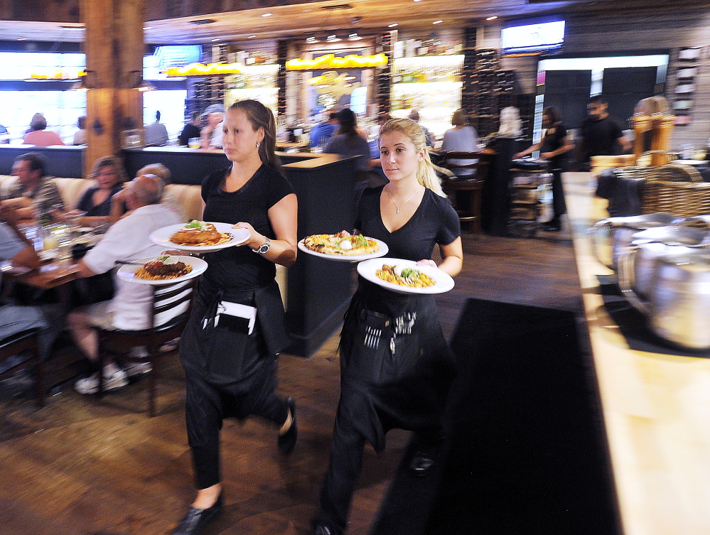 FREEPORT, ME - JULY 24: Food and atmosphere from Tuscan Grill in Freeport. Emily Martin, left, and Allie Gagne deliver the food orders pronto to patrons. (Gordon Chibroski/Staff Photographer)