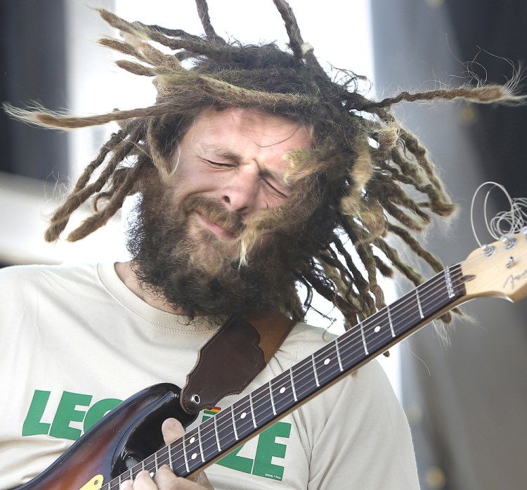 Jay Harris, lead guitarist with Soul Rebel Project, entertains the crowd during the first Portland Reggae Fest at the Maine State Pier on Sunday.