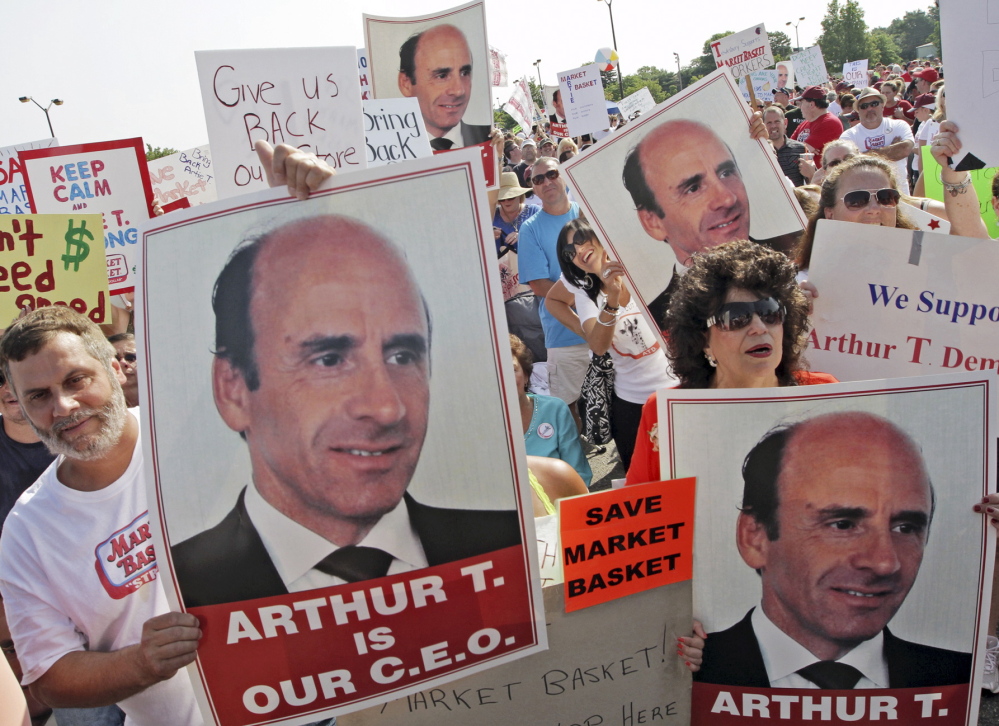 Market Basket employees and supporters hold a rally last month in Tewksbury, Mass., to back ousted former CEO Arthur T. Demoulas. 