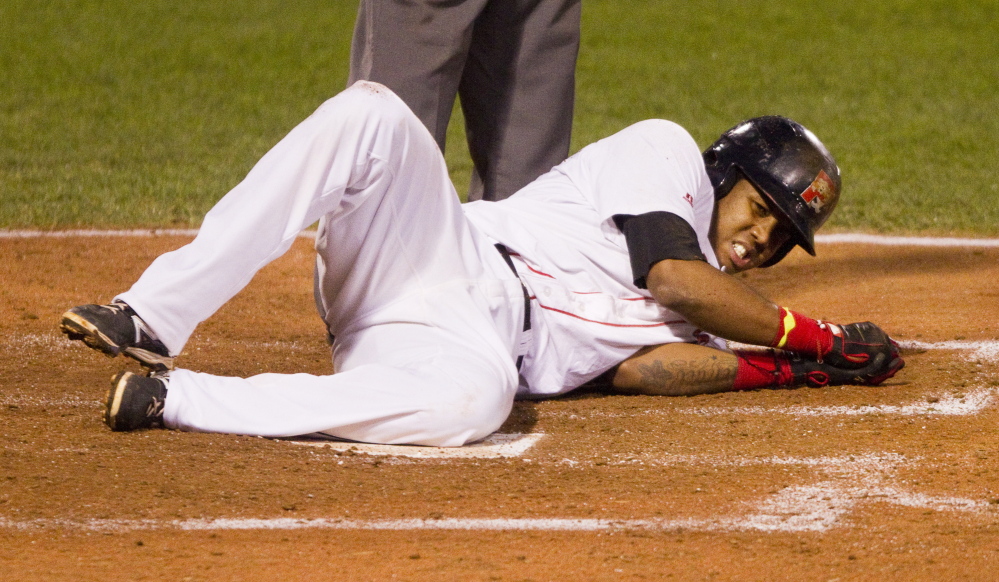 Sea Dogs' Michael Almanzar grimaces after being hit by a pitch at Hadlock Field in Portland on Tuesday.
Carl D. Walsh/Staff Photographer