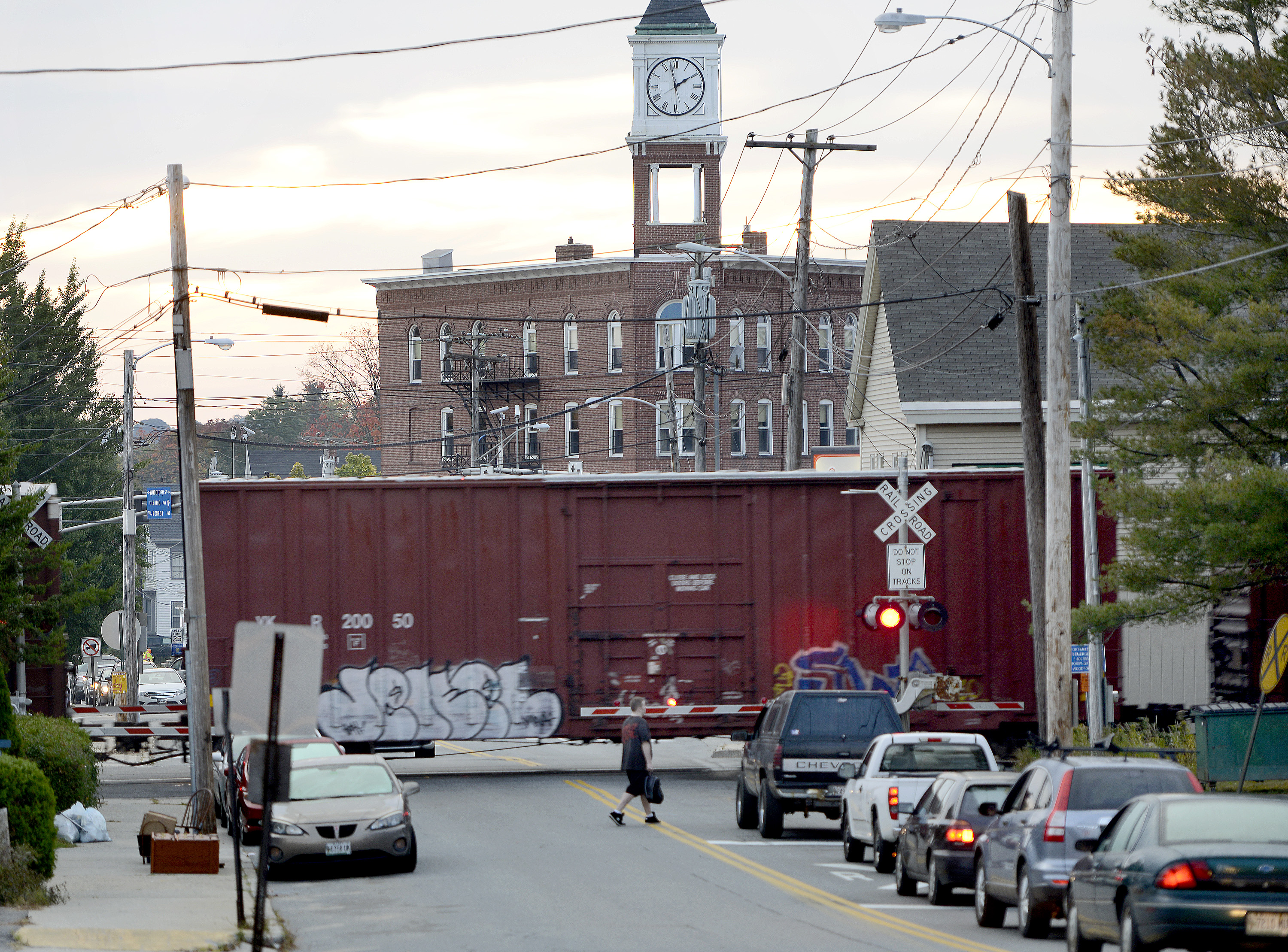 A freight train passes through Woodfords Corner in Portland. Federal money will help rehabilitate 380 miles of track throughout Maine and remove longstanding bottlenecks.