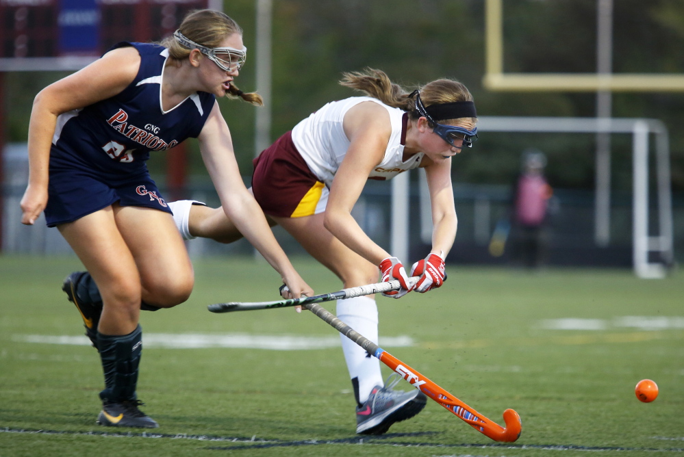 Charlotte Emerson of Cape Elizabeth, right, races to the ball ahead of Melody Larson of Gray-New Gloucester in the second half of Cape Elizabeth’s 1-0 win in a Western Maine Conference field hockey opener Wednesday.