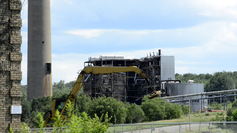 Heavy machinery chips away at what remains of the Great Northern Paper Co. mill in Millinocket.