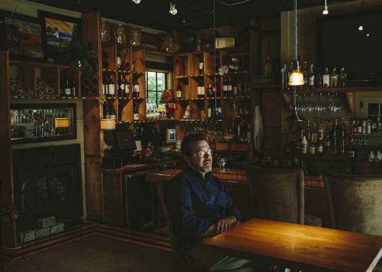 Owner Matt Mattingly sits in the wine bar at the PineCrest Inn Bed and Breakfast in Gorham as he tests software for Davo Technologies that eliminates the need for businesses to crunch their sales-tax numbers every month.