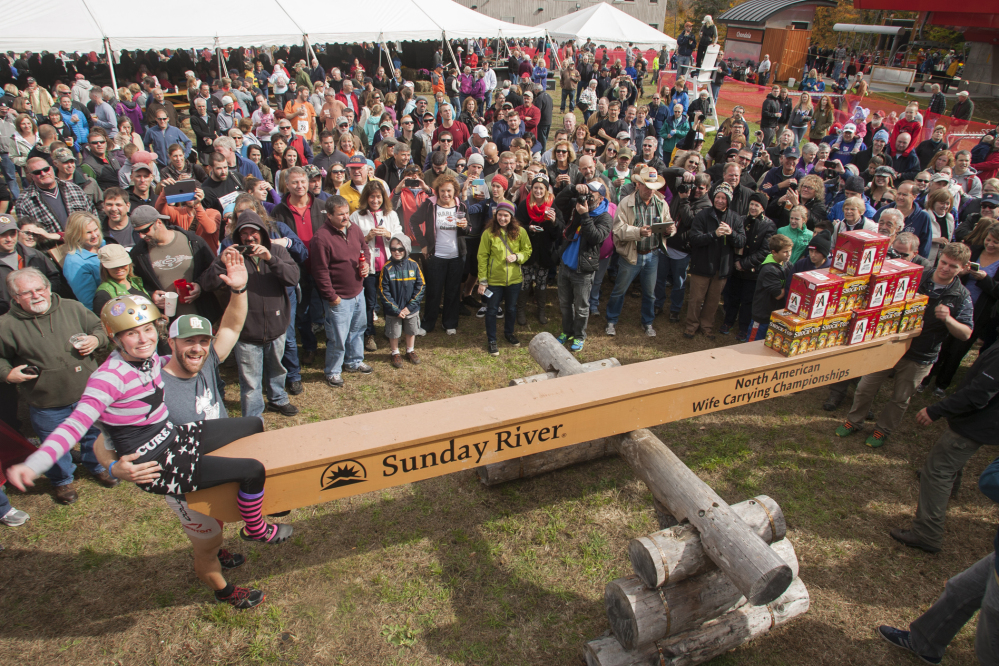 This photo courtesy of Sunday River Communications, Jesse Wall and Christina Arsenault weigh in during the the North American Wife Carrying Championship on Saturday in Newry, Maine.